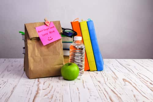 School lunch in paper bag with note that reads: "Don't forget lunch, love mom"