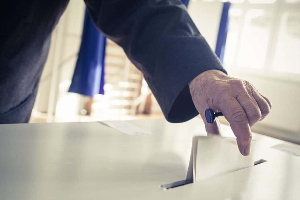 Picture of ballot being placed into a ballot box