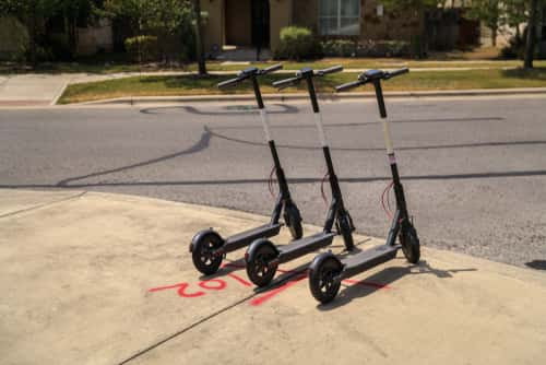 dockless scooters parked on a sidewalk