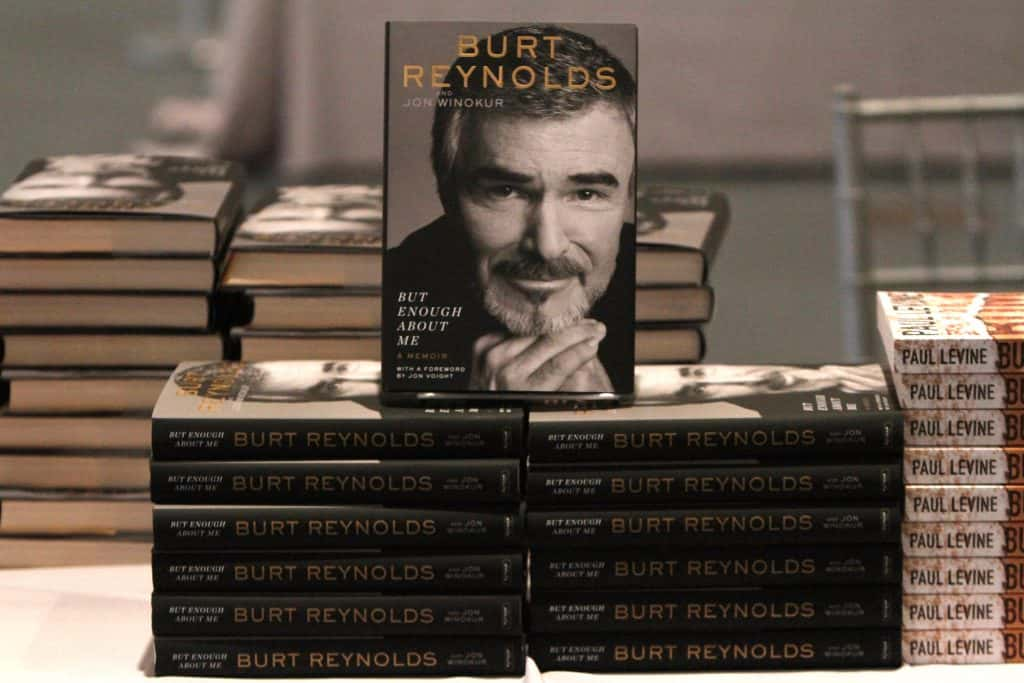 Stack of books about Burt Reynolds