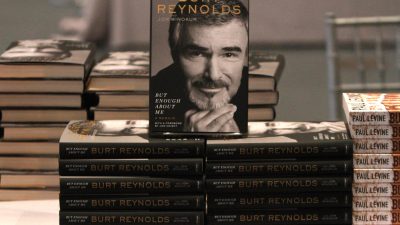 Stack of books about Burt Reynolds