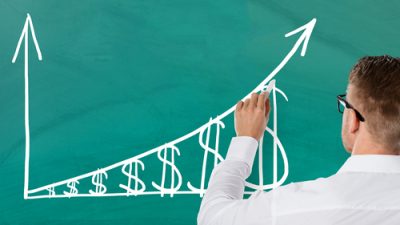 teacher writing on chalkboard