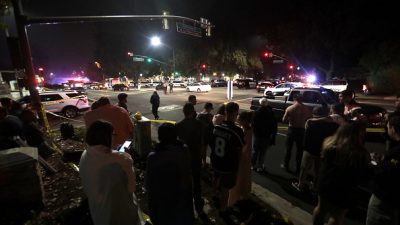 A crowd gathered by a police line outside of the Thousand Oaks shooting