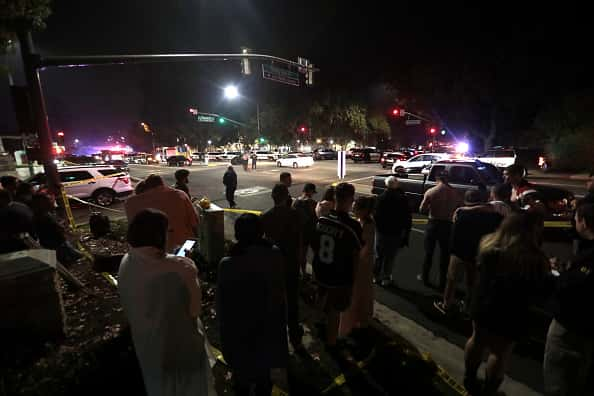 A crowd gathered by a police line outside of the Thousand Oaks shooting