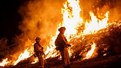 Firefighters trying to tame a wildfire