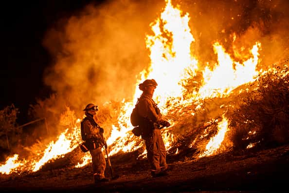 Firefighters trying to tame a wildfire