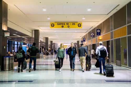 Travelers walking through austin bergstrom international airport