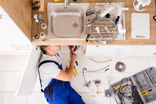 Plumber working on sink