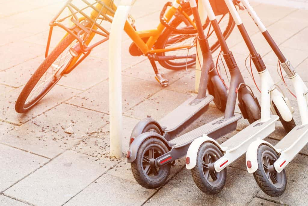 Dockless electric scooters and bicycle on city street