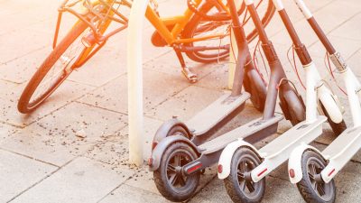 Dockless electric scooters and bicycle on city street