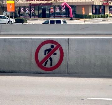 No pedestrian crossing sign on I-35 barriers