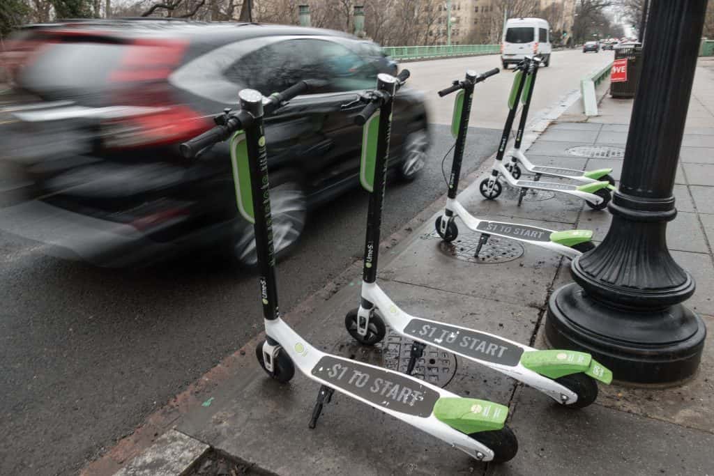 A trio of Lime Bikes on the sidewalk