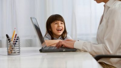 A young girl watches her mother work