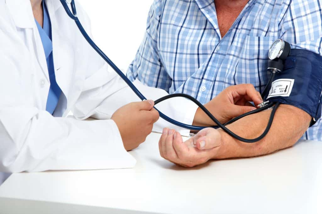 Person getting blood pressure measured by a doctor