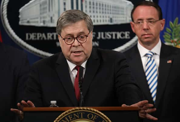 Attorney General William Barr at a news conference behind a podium