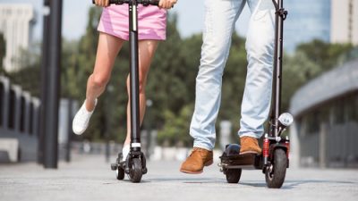 people riding electric scooters