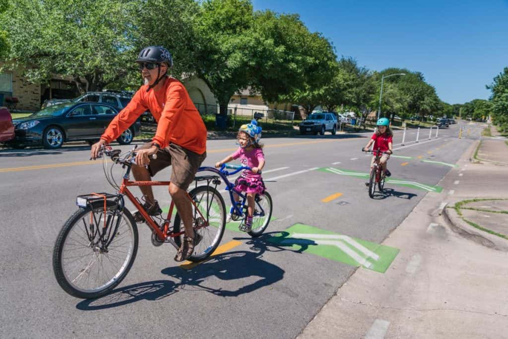 A family rides bikes in an Austin bike lane