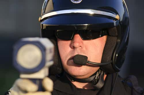 Cop pointing radar gun