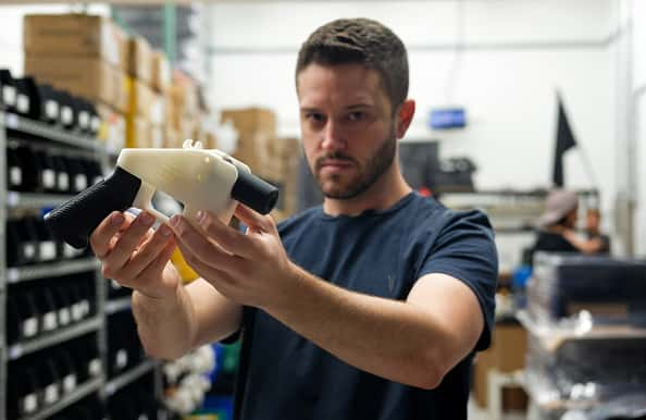 Cody Wilson Owner of Defense Distributed holding a 3D printed gun