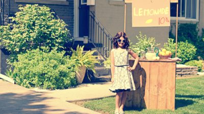 retro girl in front of lemonade stand