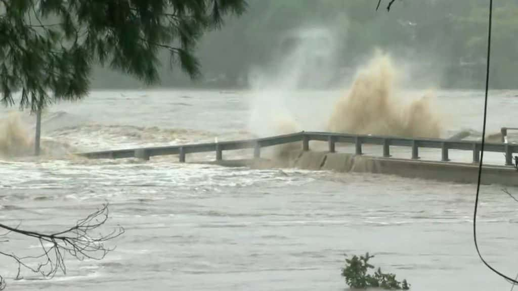 Flood waters wash away the RM 2900 bridge in Kingsland