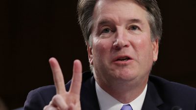 Brett Kavanaugh at the Senate Judiciary Committee Hearings showing the peace sign