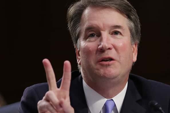 Brett Kavanaugh at the Senate Judiciary Committee Hearings showing the peace sign