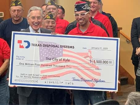 Bob Gregory, co-owner of TDS, and Bobby Diaz, Kyle VFW Post Commander, holding a check for $1.5 million.