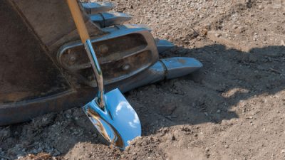 Shovel resting against a construction vehicle
