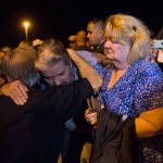 Ted and Ann Montgomery, employees at the First Baptist Church, are comforted by Texas Governor Greg Abbott (L) following a candlelight vigil held across the street from the church on November 5, 2017. 