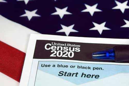 American Flag and Census paper that says "United States Census 2020"