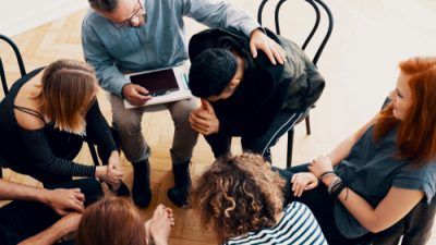 Counselor with students sitting in a circle