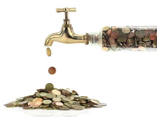 coins falling out of a water faucet