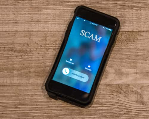 Phone receiving call that says "Scam"