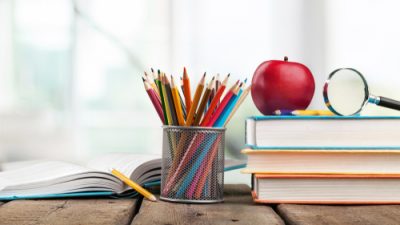 school supplies with an apple