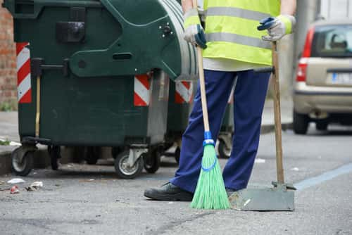 Person cleaning streets with broom