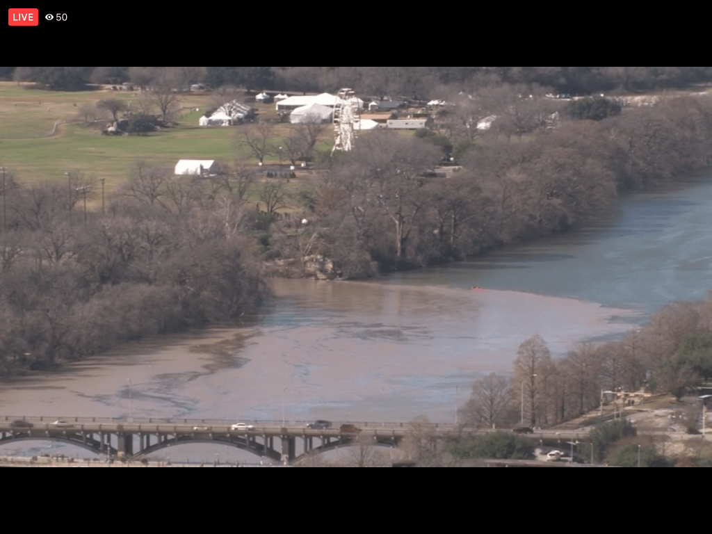 screenshot of Fox 7 tower cam video showing muddy discharge into Ladybird Lake from Barton Springs