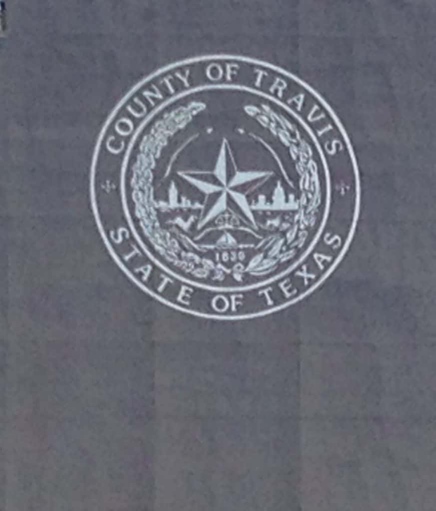 Travis County symbol on sign in downtown Austin