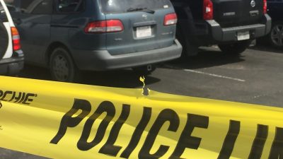 Car damaged by gunfire, police tape