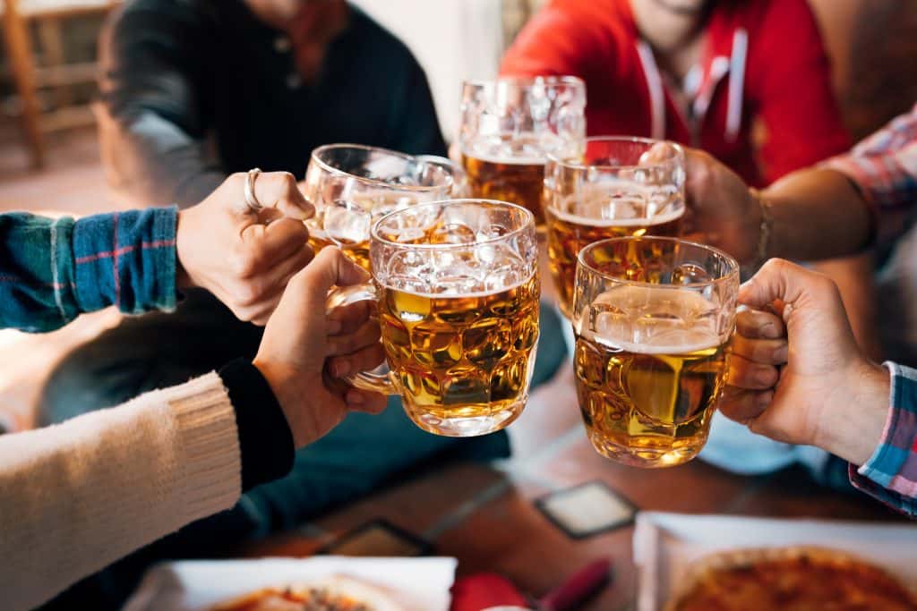 people toasting with beers