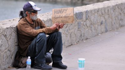 Homeless man holding a sign