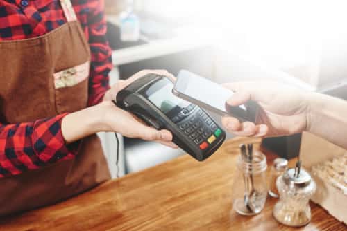 Person paying for transaction with smart phone