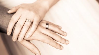 Two people hold hands