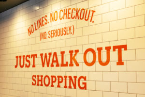 Amazon Go sign that reads "No Lines. No Checkout. (No seriously) Just Walk Out Shopping"