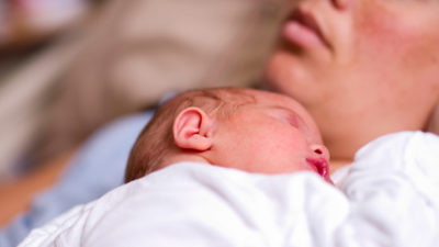 sleeping-newborn-baby-exhausted-mother