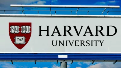 billboard displaying logo of Harvard University^ a private Ivy League research university in Cambridge^ Massachusettsl