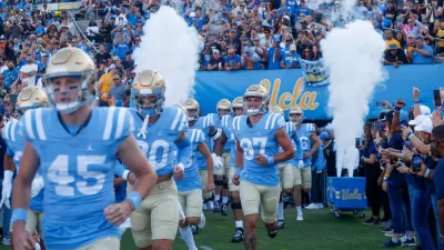 UCLA players run out of the tunnel before an NCAA college football game between the UCLA and the Colorado^ Oct. 28^ 2023^ in Pasadena^ Calif.