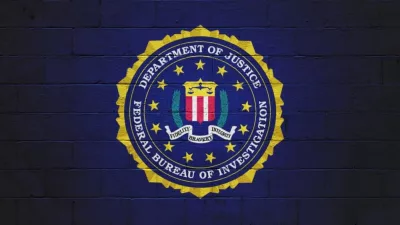 The FBI flag (Federal Bureau of Investigation) painted on a brick wall.