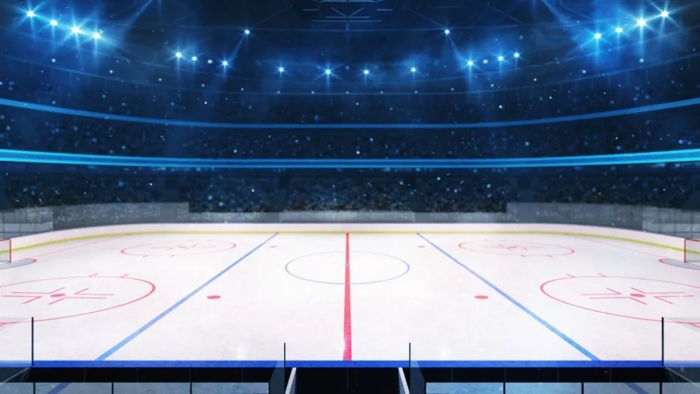 Grand ice hockey rink and illuminated indoor arena with fans^ tribune side view^ professional hockey sport 3D render illustration background