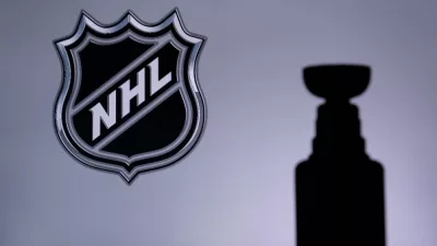 National Hockey LeagueLogo of NHL club on the screen. Stenley Cup Trophy Silhouette.